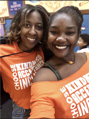 teachers dressed in orange t-shirts 